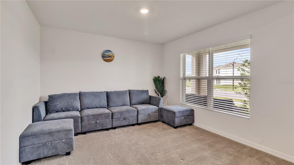 16614 Windmill Forge Pass Wimauma, FL 33598 - Photo 5 of 18 a living room with furniture and a window