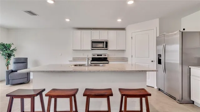 a kitchen with stainless steel appliances a refrigerator and a stove top oven