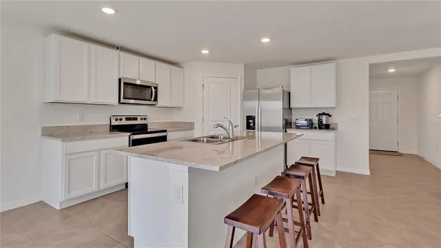 a kitchen with cabinets a sink and appliances