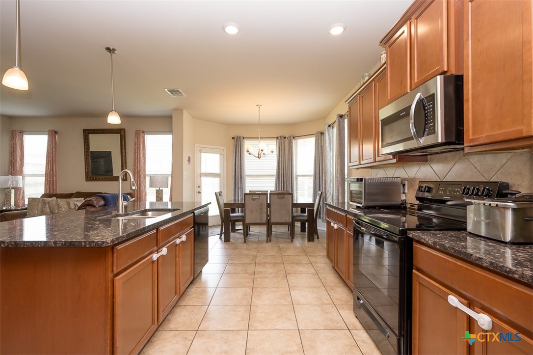2511 Pintail Loop Copperas Cove, TX 76522 - Photo 8 of 26 a large kitchen with stainless steel appliances granite countertop a lot of counter space and a sink