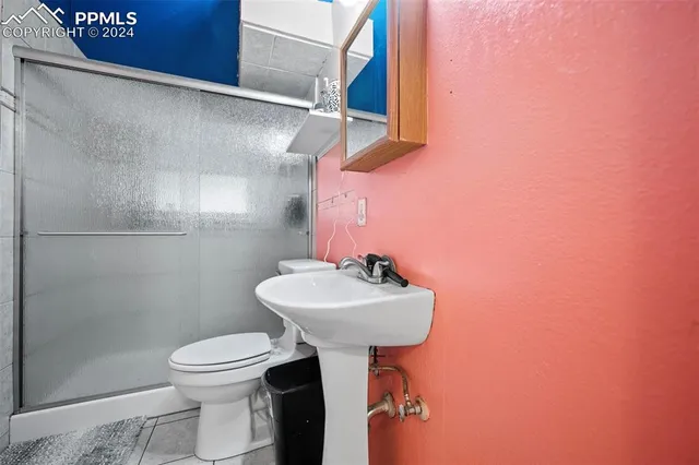 a bathroom with a sink toilet and a mirror