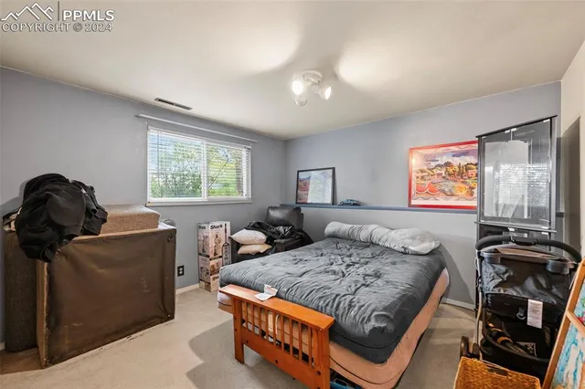 a bedroom with furniture and a window