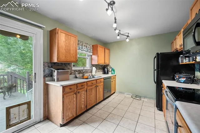 a kitchen with a sink window and cabinets