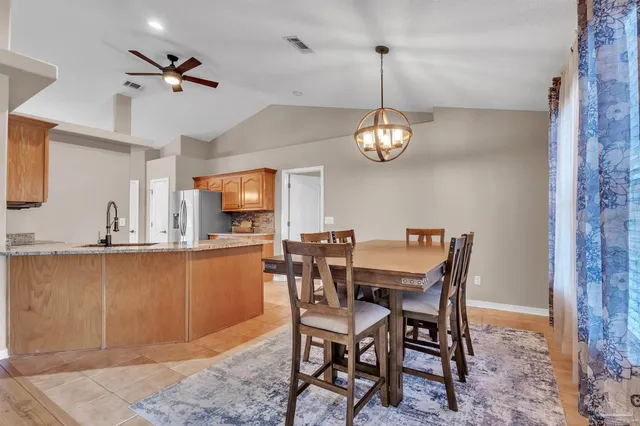 a view of a dining room with furniture wooden floor and a chandelier