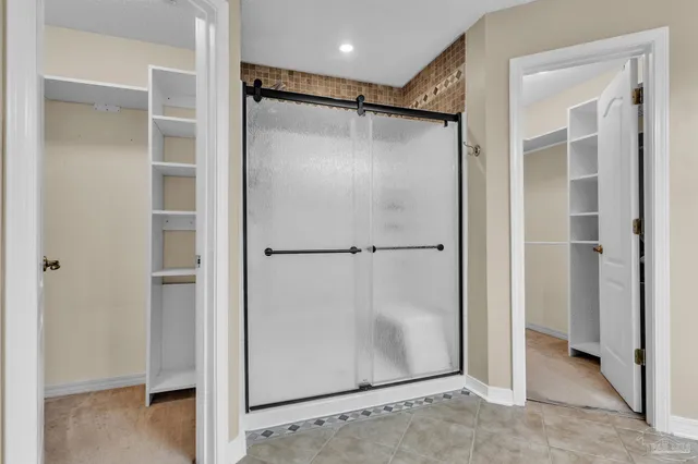 a bathroom with a shower and a glass door
