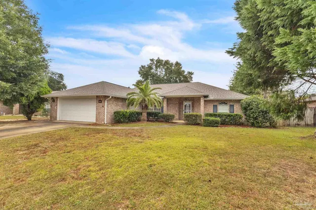 a front view of house with yard and trees