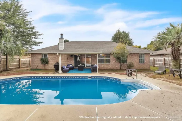 a view of a house with swimming pool and sitting area
