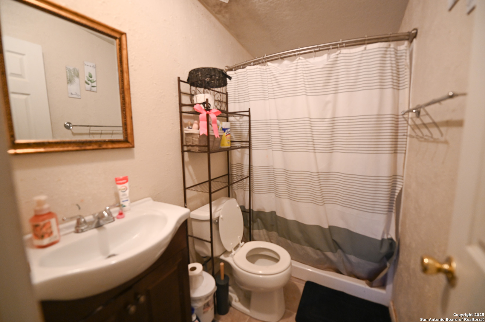 42 Mobile Road Cotulla, TX 78014 - Photo 11 of 21 a bathroom with a sink and a mirror