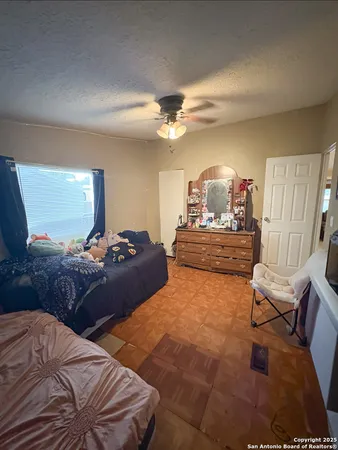 a bedroom with double bed and a chandelier