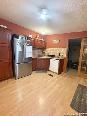 a kitchen with kitchen island a counter top space cabinets and stainless steel appliances