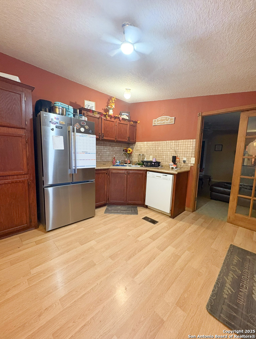 42 Mobile Road Cotulla, TX 78014 - Photo 14 of 21 a kitchen with kitchen island a counter top space cabinets and stainless steel appliances