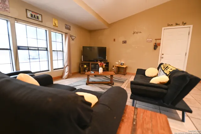 a living room with furniture and a flat screen tv