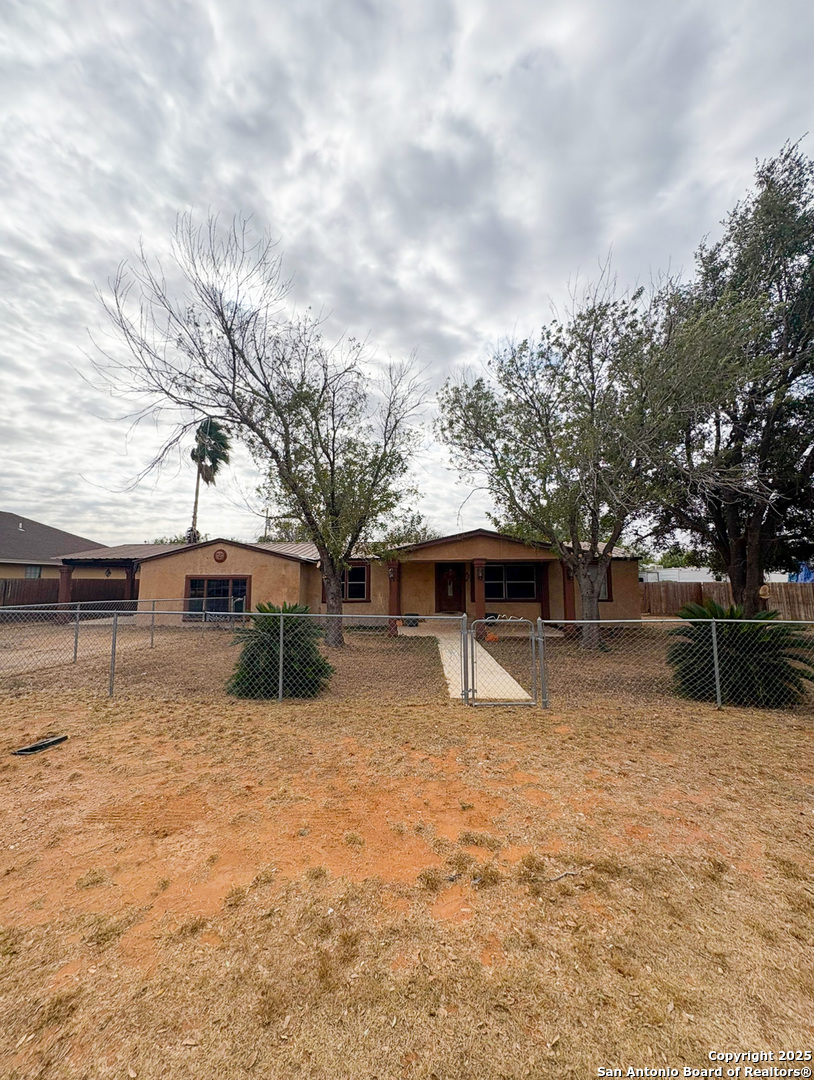 42 Mobile Road Cotulla, TX 78014 - Photo 2 of 21 a backyard of a house with yard and garage