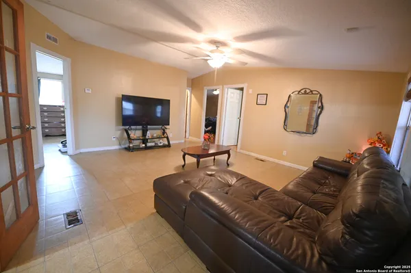 a living room with furniture and a flat screen tv