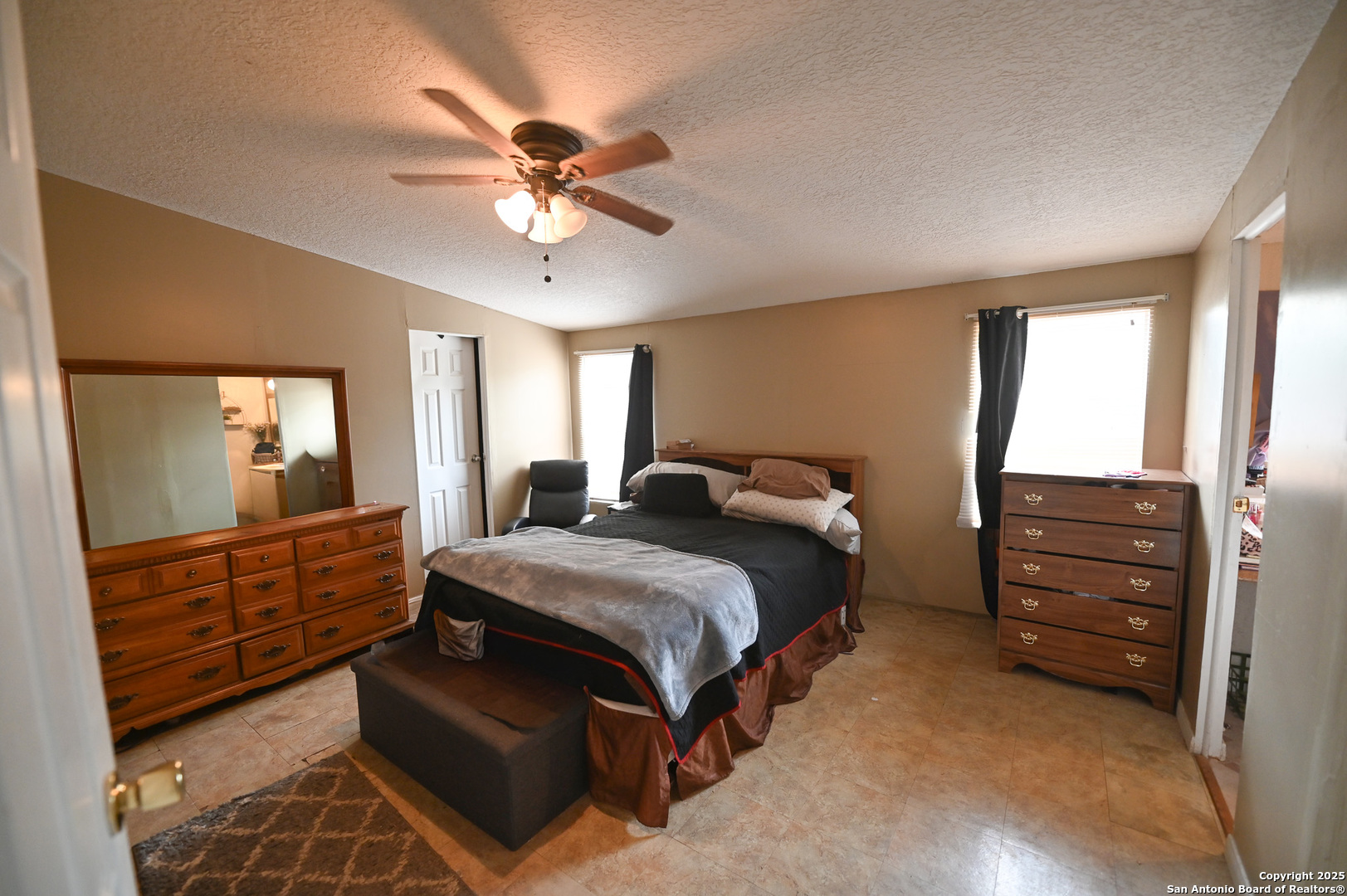 42 Mobile Road Cotulla, TX 78014 - Photo 7 of 21 a bedroom with a bed and a dresser