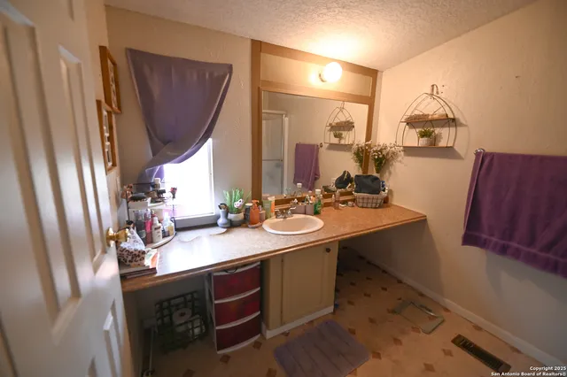 a bathroom with double vanity sink and a mirror