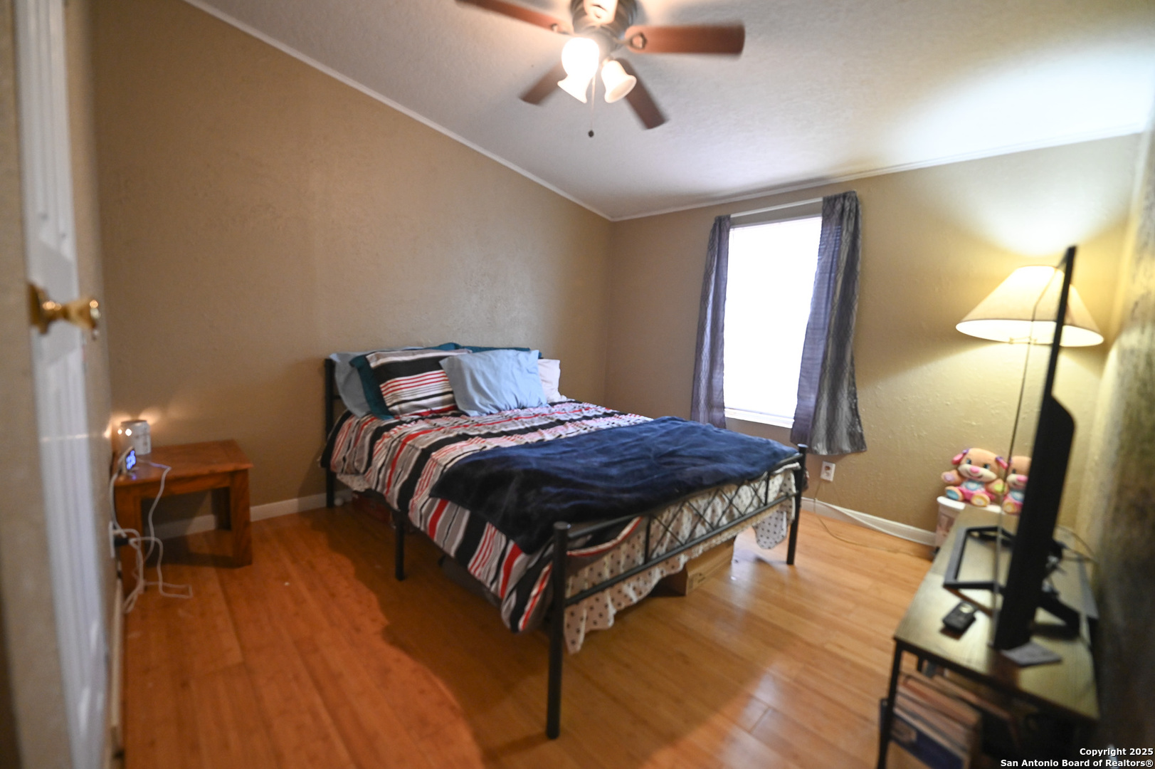 42 Mobile Road Cotulla, TX 78014 - Photo 10 of 21 a spacious bedroom with a bed table closet and a lamp