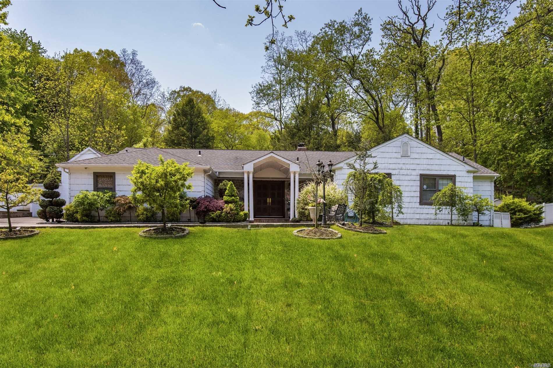 a front view of a house with garden and porch