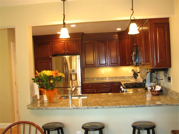 5 Trail Ridge Way, Unit D Harvard, MA 01451 - Photo 23 of 30 a kitchen with a refrigerator coffee maker on granite counter tops