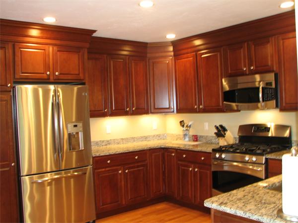 5 Trail Ridge Way, Unit D Harvard, MA 01451 - Photo 24 of 30 a kitchen with stainless steel appliances granite countertop wooden cabinets a stove top oven a sink and dishwasher