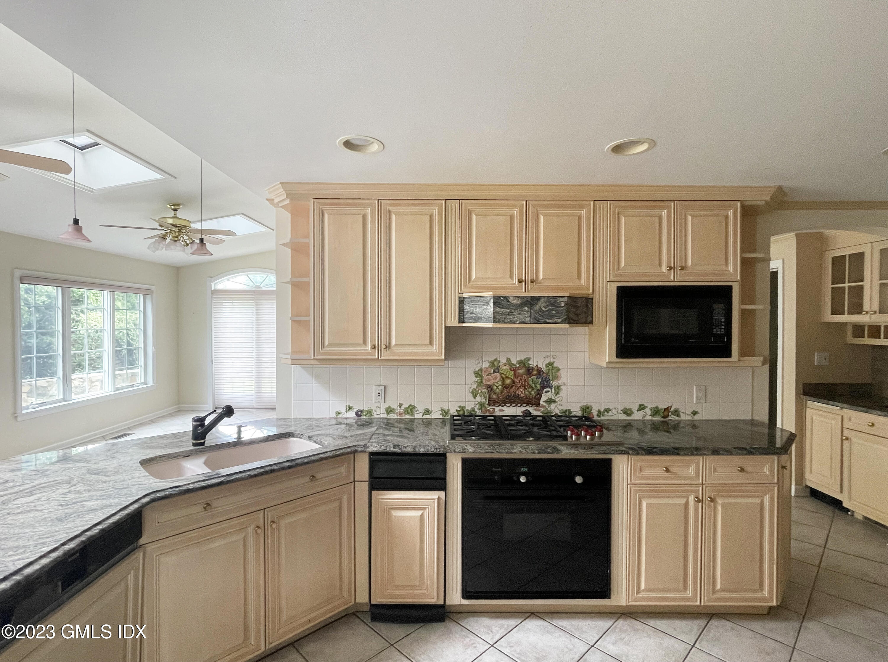 30 Split Timber Place Riverside, CT 06878 - Photo 18 of 45 a kitchen with granite countertop a sink and cabinets