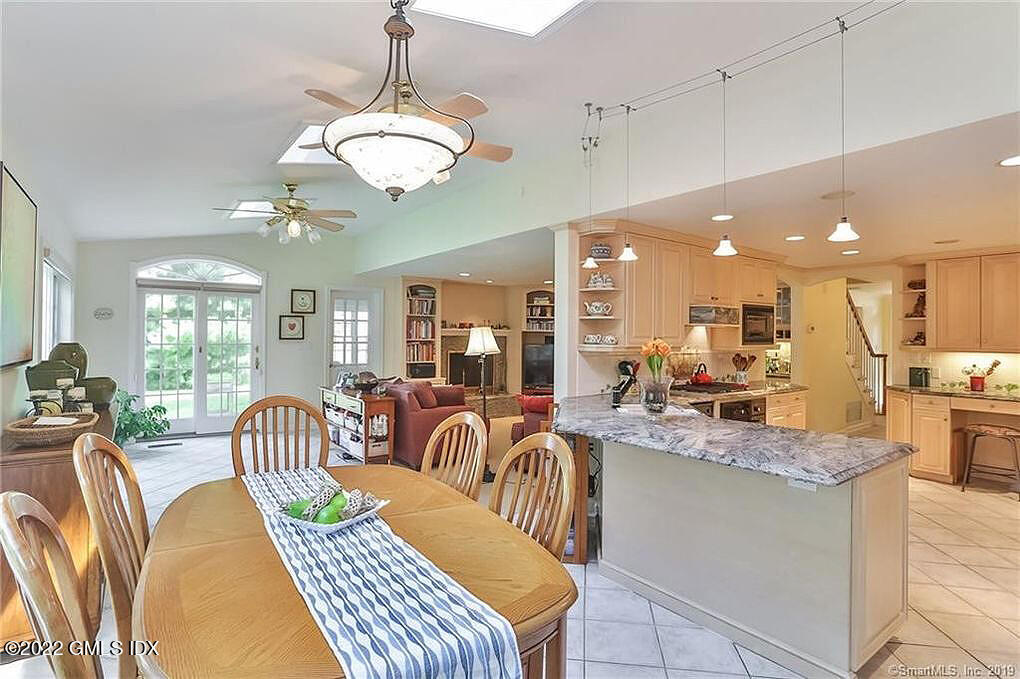 30 Split Timber Place Riverside, CT 06878 - Photo 20 of 45 a view of a dining room and livingroom with furniture wooden floor a rug a chandelier and a mirror