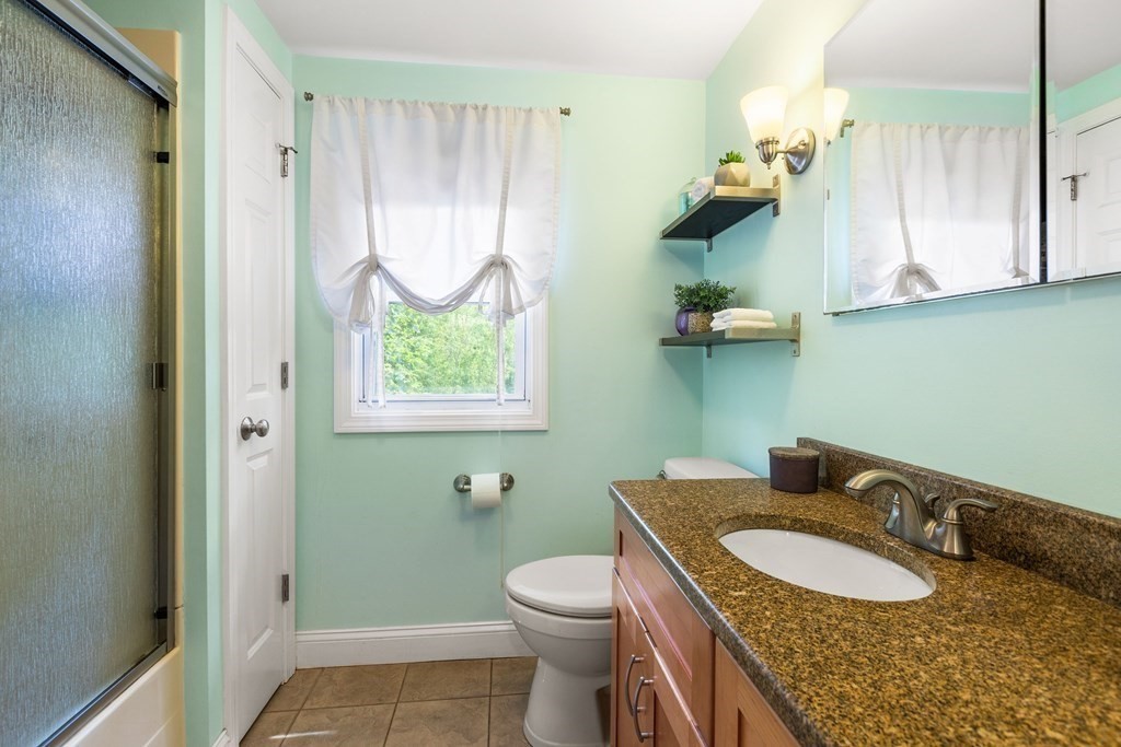 47 Victor Street Acushnet, MA 02743 - Photo 25 of 31 a bathroom with a granite countertop toilet sink and mirror