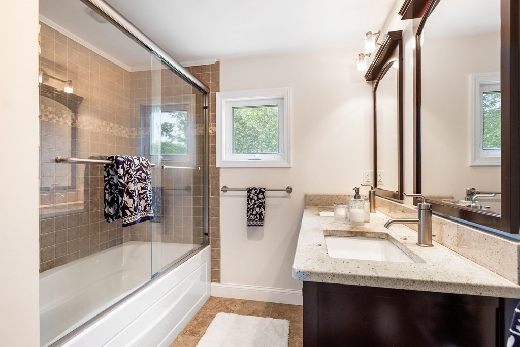 47 Victor Street Acushnet, MA 02743 - Photo 27 of 31 a bathroom with a granite countertop sink a large mirror and a bathtub