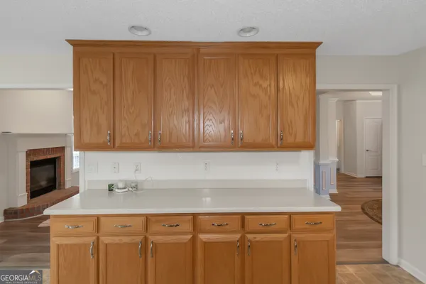 a kitchen with a sink cabinets and a fireplace