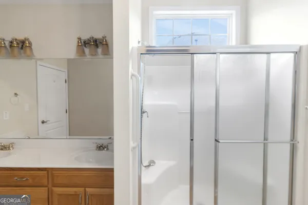 a bathroom with a granite countertop sink