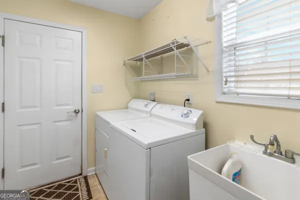 a utility room with a sink dryer and washer