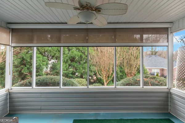 a view of a room that has a window and a ceiling fan
