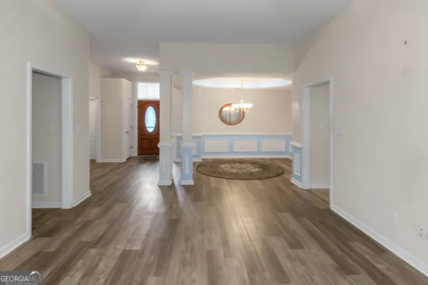 a view of a room with wooden floor