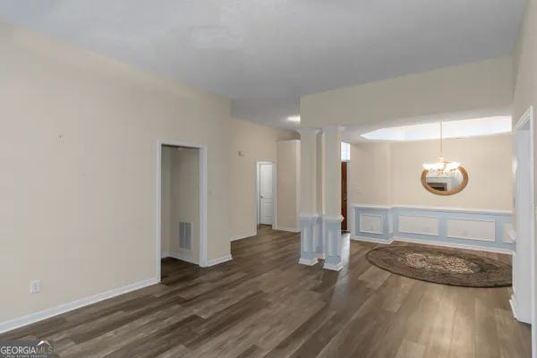 a view of a room with wooden floor