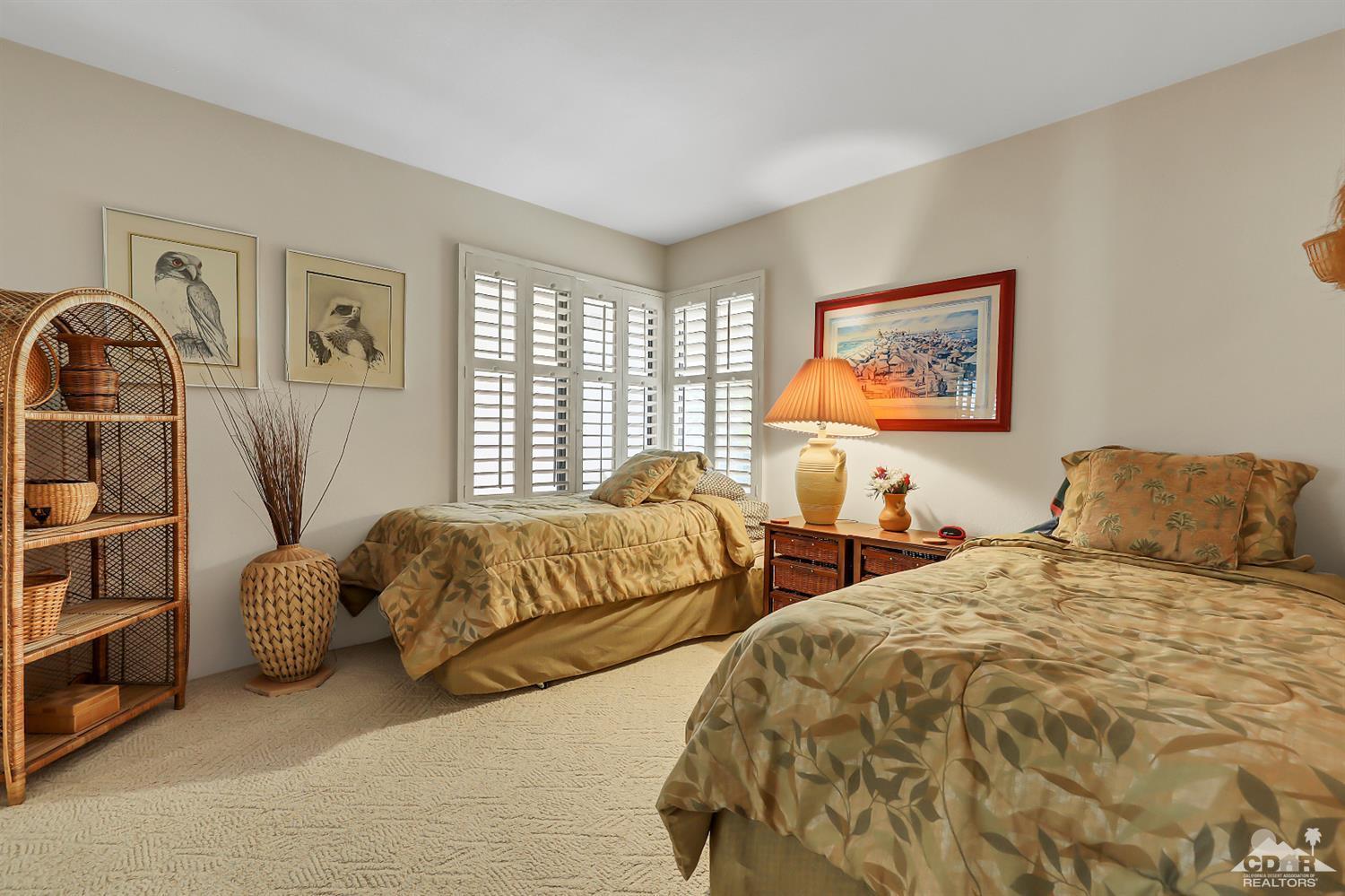 6 Palomas Drive Rancho Mirage, CA 92270 - Photo 12 of 20 a bedroom with two beds and a window