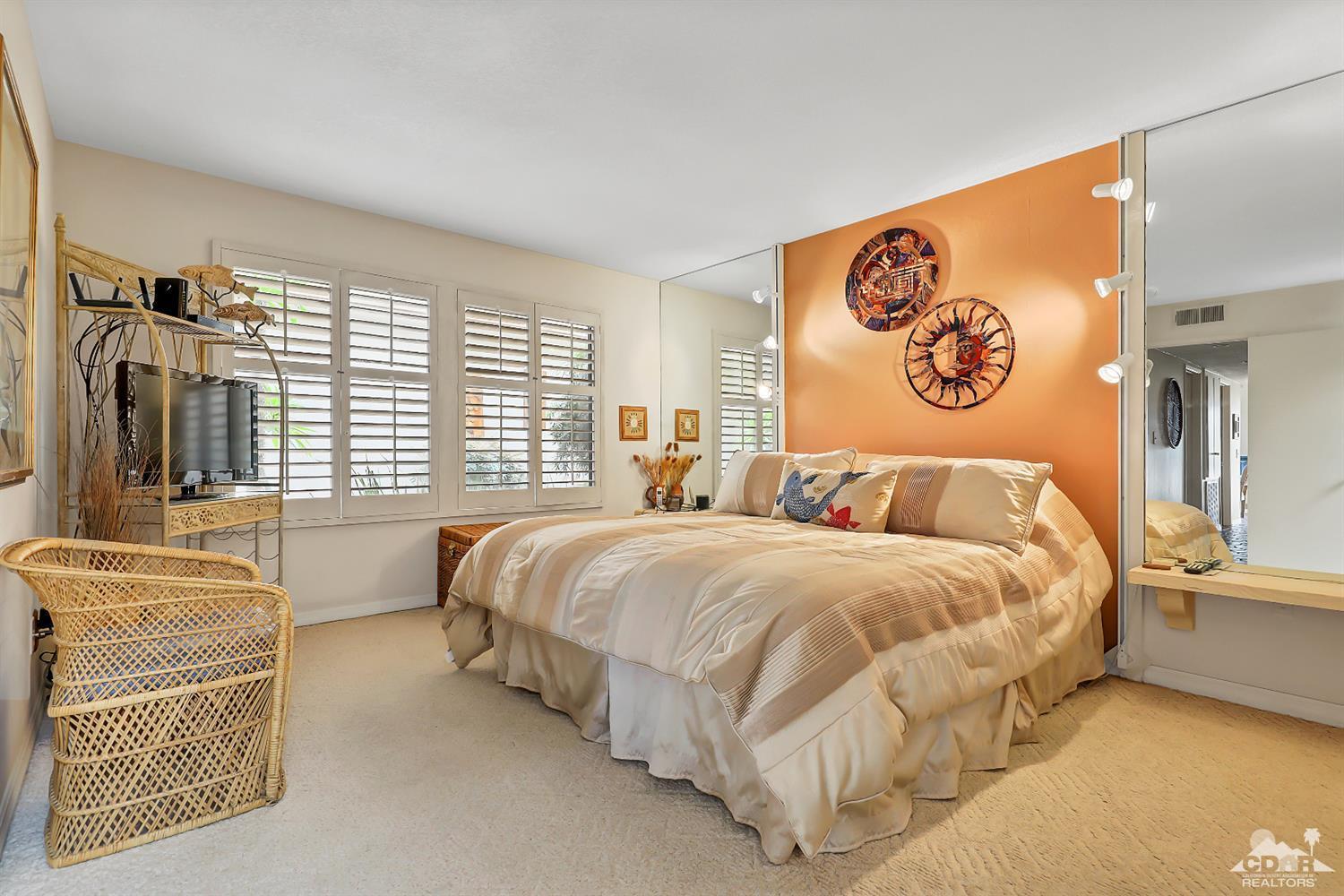 6 Palomas Drive Rancho Mirage, CA 92270 - Photo 13 of 20 a spacious bedroom with a bed and glass windows