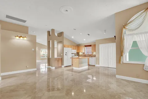 a view of a kitchen with refrigerator and cabinets