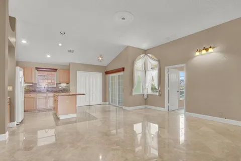 a view of a kitchen with kitchen island granite countertop living room