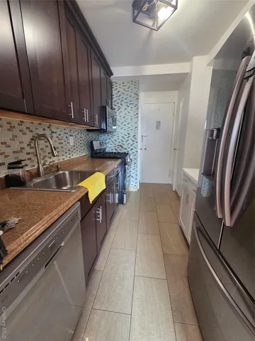 a kitchen with a stove and a refrigerator