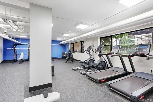 a room with gym equipment and a large window