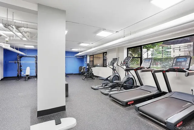 a room with gym equipment and a large window