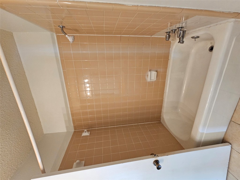 6000 Emerald Forest Drive, Unit A Austin, TX 78745 - Photo 11 of 19 a bathroom with a bathtub and a shower