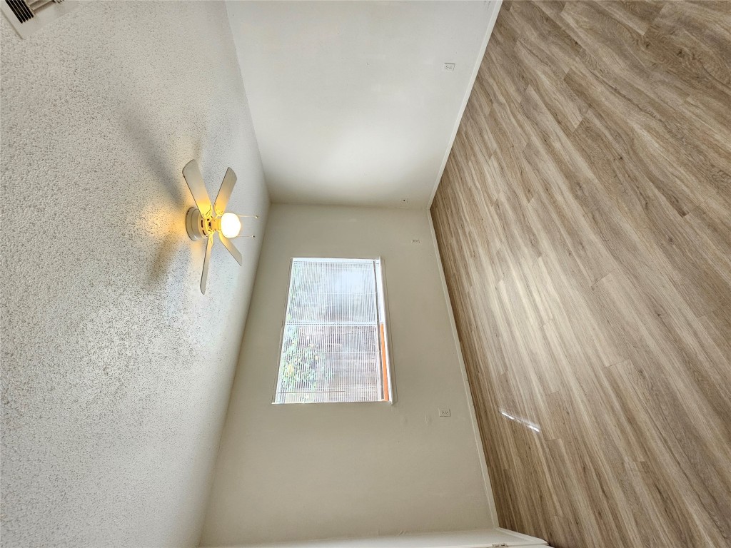 6000 Emerald Forest Drive, Unit A Austin, TX 78745 - Photo 12 of 19 an empty room with wooden floor and windows