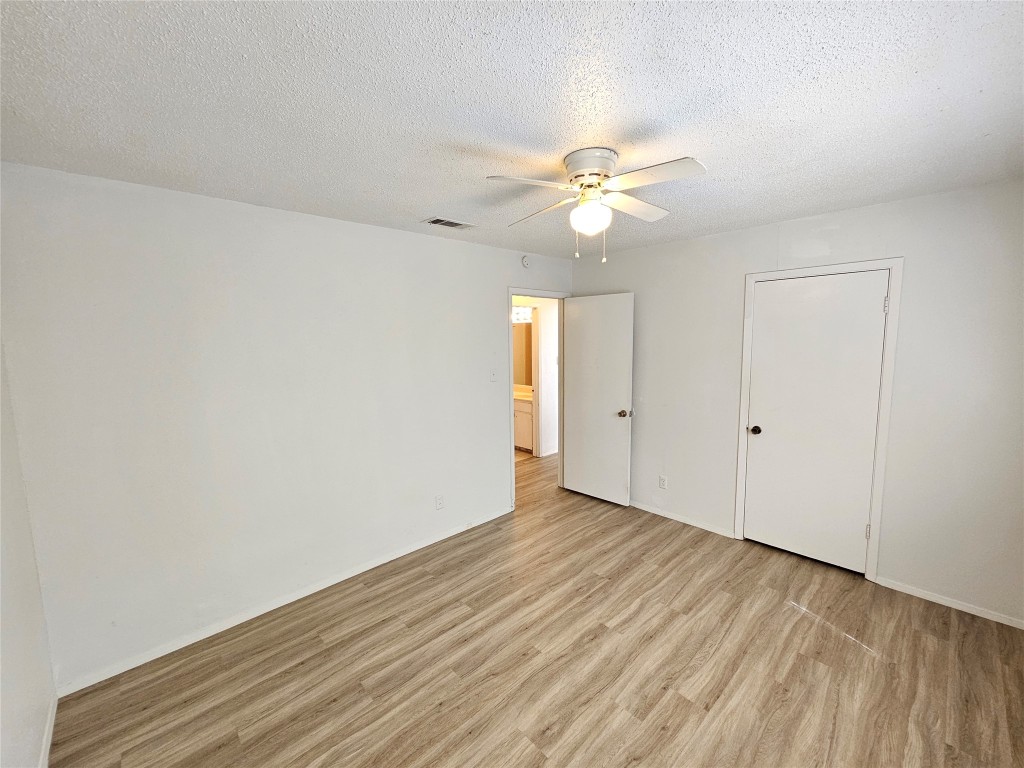 6000 Emerald Forest Drive, Unit A Austin, TX 78745 - Photo 13 of 19 wooden floor in an empty room
