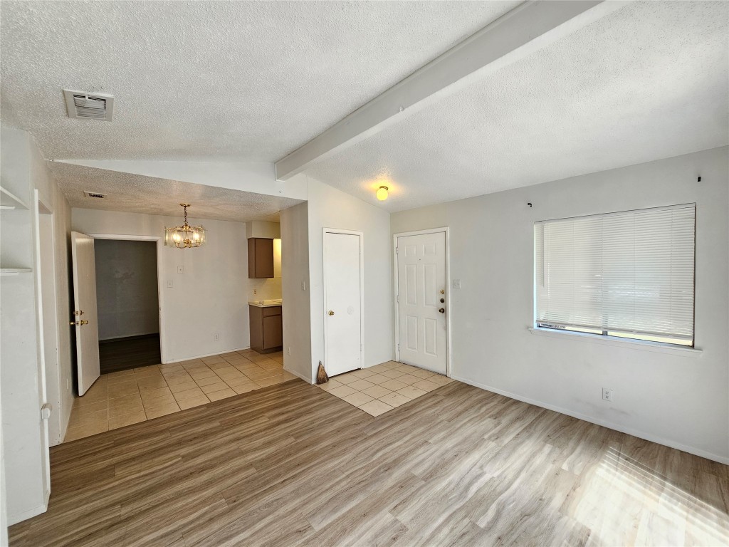 6000 Emerald Forest Drive, Unit A Austin, TX 78745 - Photo 4 of 19 a view of an empty room with wooden floor