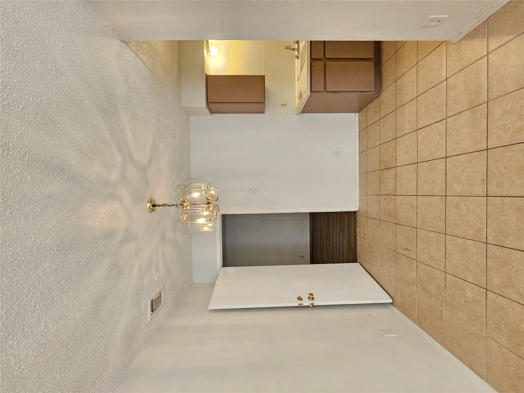 6000 Emerald Forest Drive, Unit A Austin, TX 78745 - Photo 5 of 19 a view of a kitchen with a sink and a microwave