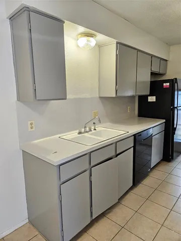 a utility room with cabinets washer and dryer