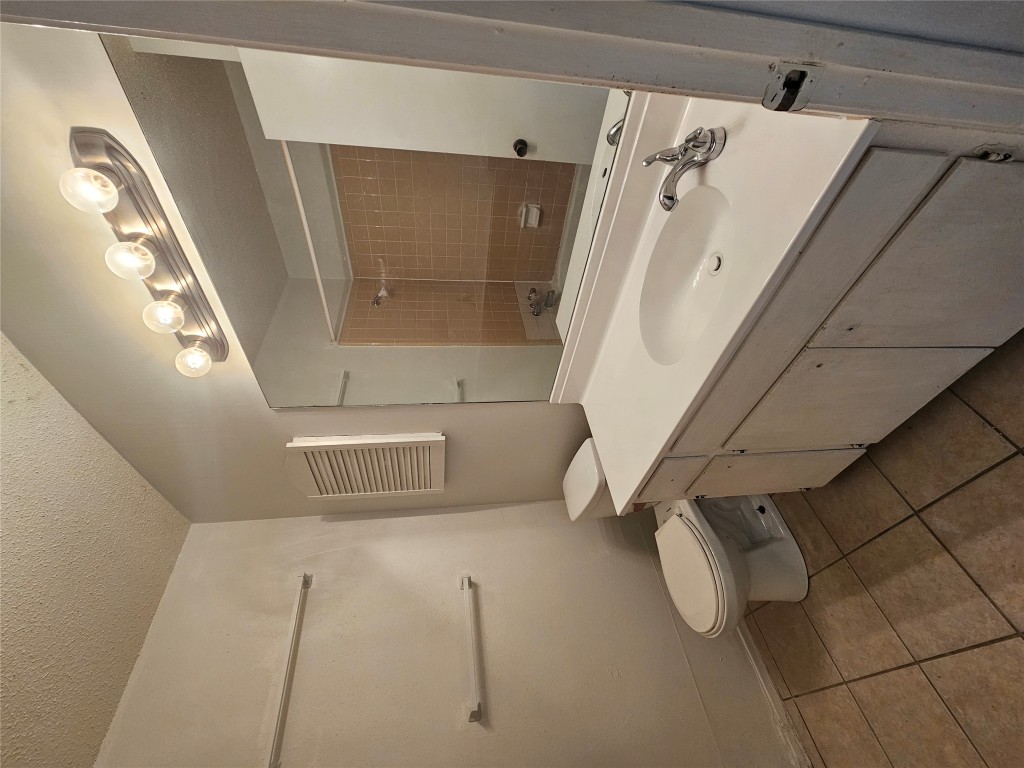6000 Emerald Forest Drive, Unit A Austin, TX 78745 - Photo 10 of 19 a bathroom with a sink toilet and mirror