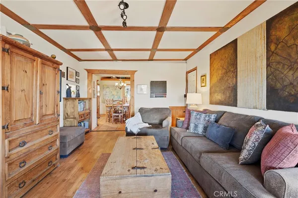 a living room with furniture a flat screen tv and a table