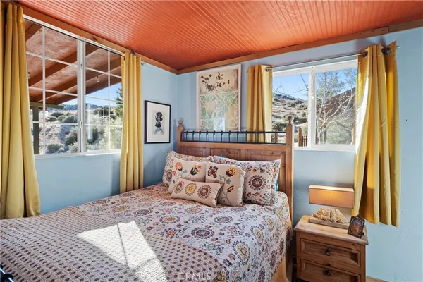 a bedroom with two beds and a window
